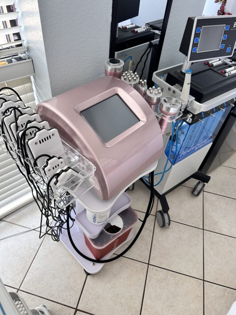 Professional aesthetician performing RF facial session in clinic setting.  
